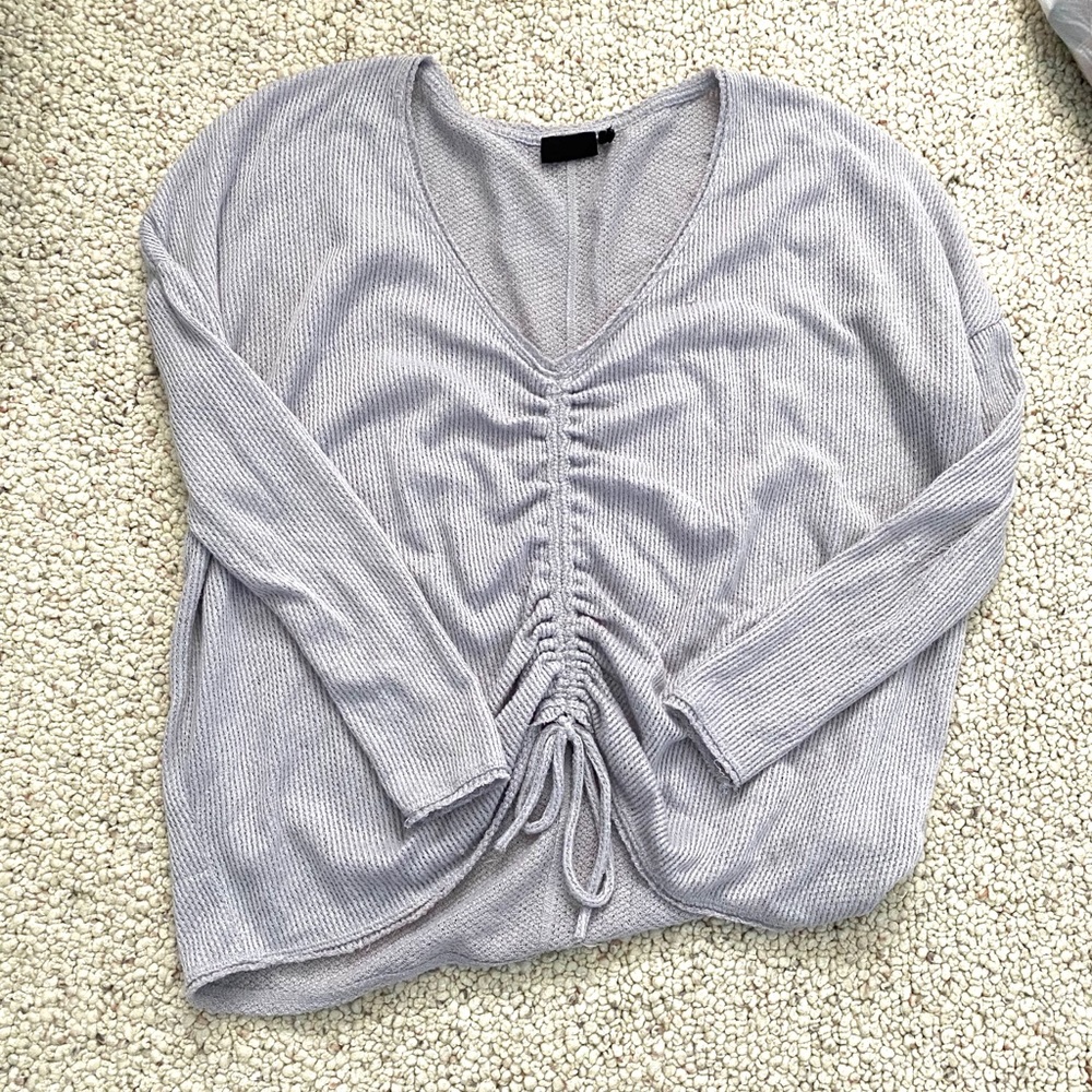 Out from under oversized scrunched sweater